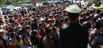 Worldwide Attacks on Freedom of Expression? 4 0347801c24cd85717cbdfa2cab2d329dc67a5659 225710 china paramilitary policeman watches over crowds