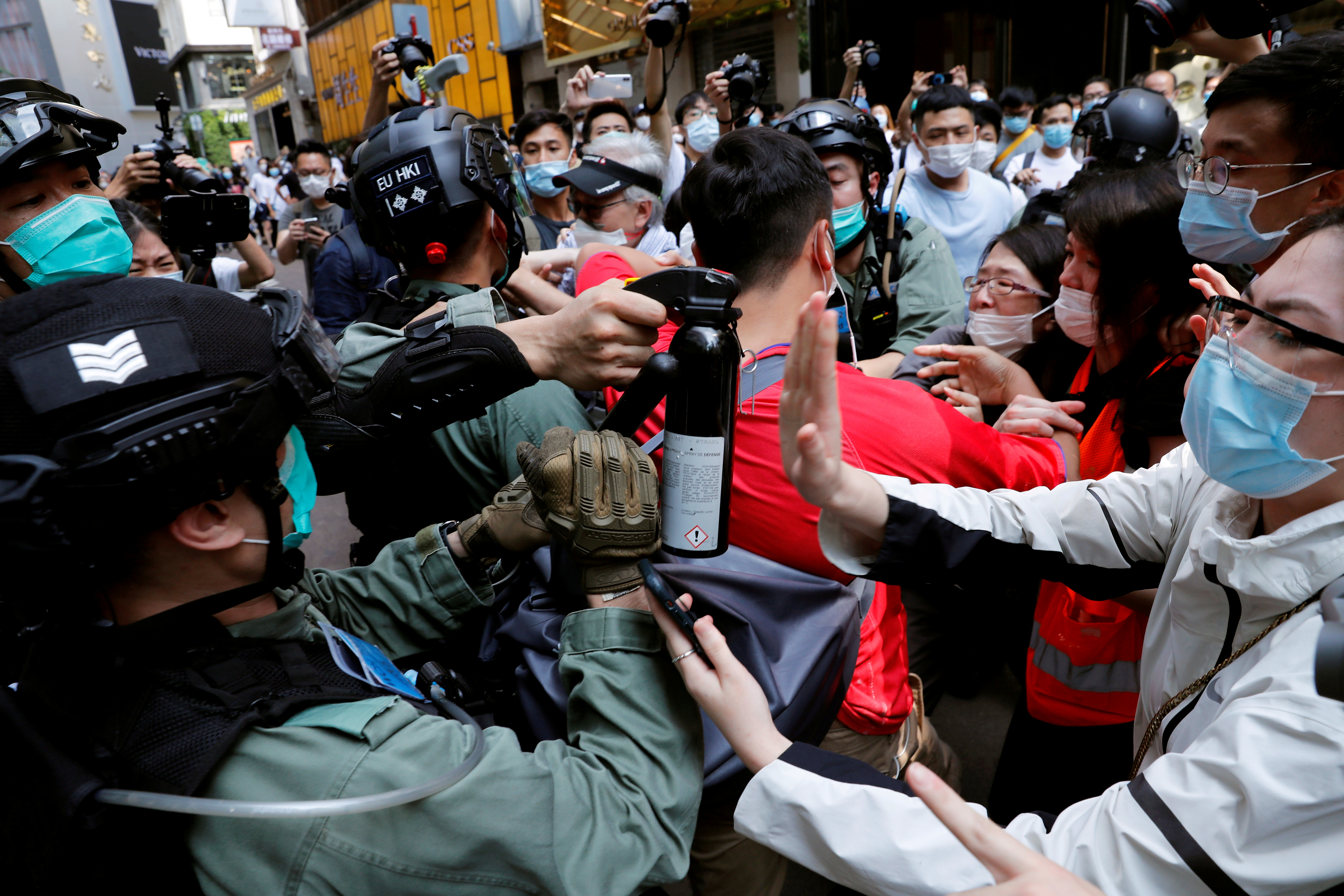 FILE PHOTO: Anti-government demonstrators scuffle with riot police during a lunch time protest as a second reading of a controversial national anthem law takes place in Hong Kong, China May 27, 2020. REUTERS/Tyrone Siu/File Photo