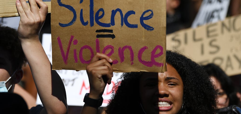 Demonstrators carry placards with slogans as they march near the US Embassy in London on May 31, 2020 to protest the death of George Floyd, an unarmed black man who died after a police officer knelt on his neck for nearly nine minutes during an arrest in Minneapolis, USA. - Hundreds gathered in central London and marched to teh US Embassy to protest the death of an unarmed black man in Minneapolis while in police custody that has sparked days of unrest in the US city and beyond. (Photo by DANIEL LEAL-OLIVAS / AFP)