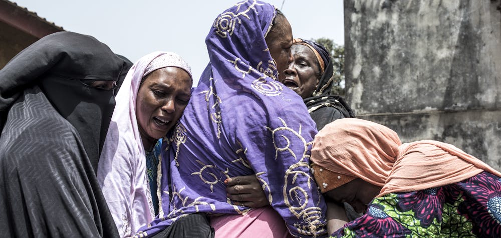 Family and community members mourn the death of Kudidiabou Bah in Conakry on March 01, 2020. - Kudidiabou, who was pregnant, allegedly succumbed internal bleeding caused after an altercation with security forces during a protest on February 29, 2020. Guinea's opposition on February 29, 2020 called for the cancellation of a referendum on changing the constitution, as fresh protests against President Alpha Conde's government broke out in the capital Conakry. The referendum will decide whether to adopt a new constitution, which includes bans on female circumcision and underage marriage in the West African country. (Photo by JOHN WESSELS / AFP)