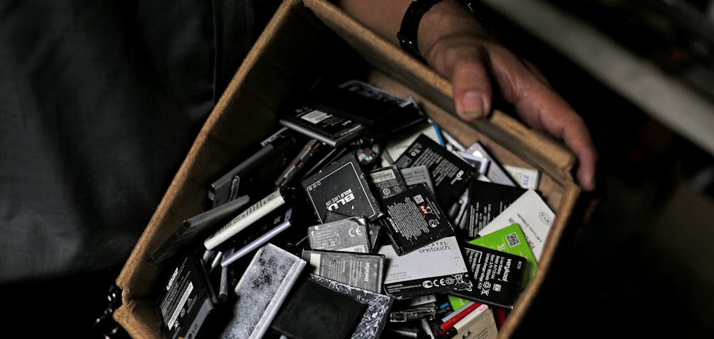 A man shows batteries from discarded cell phones in a box in his stall at the Oriental Market in Managua, Nicaragua October 23, 2018. REUTERS/Jorge Cabrera