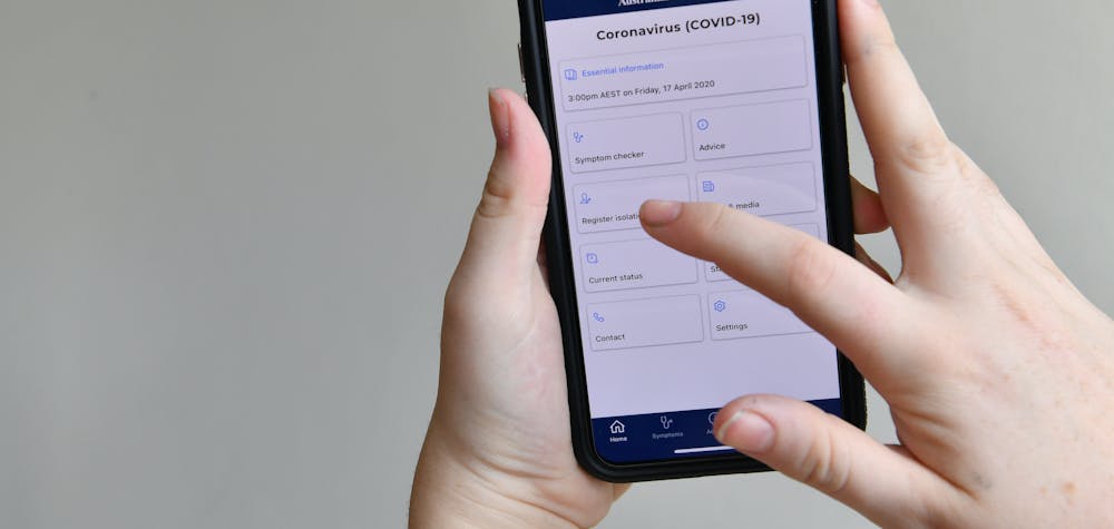 A person is seen using the Australian government coronavirus (COVID-19) app on an iPhone in Brisbane, Saturday, April 18, 2020. Prime Minister Scott Morrison has ruled out forcing Australians to download a coronavirus tracing app which would use data from people's phones to inform health authorities of close contacts of confirmed COVID-19 cases.  (AAP Image/Darren England) NO ARCHIVINGNo Use Australia. No Use New Zealand.