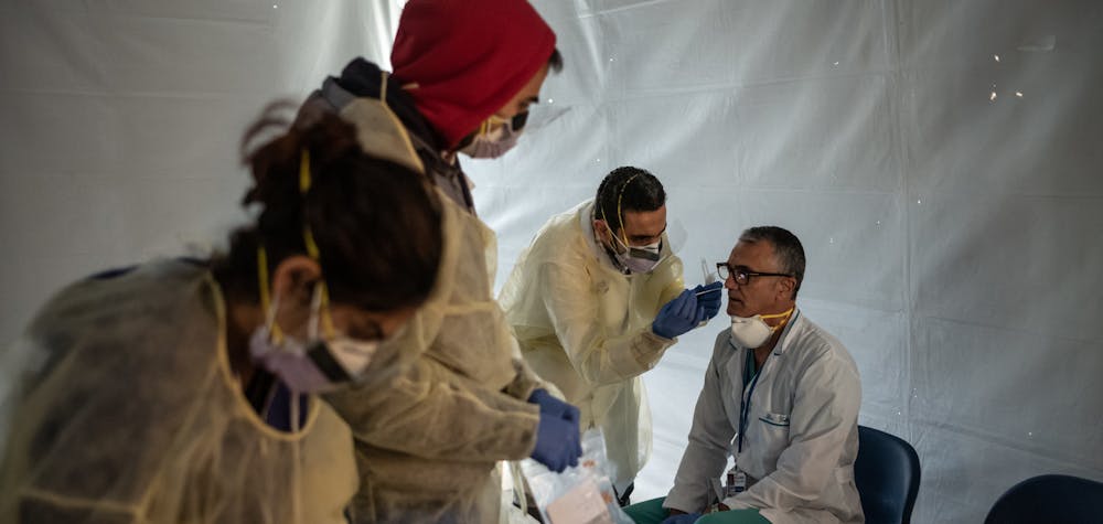  	NEW YORK, NY - MARCH 24: Doctors test hospital staff with flu-like symptoms for coronavirus (COVID-19) in set-up tents to triage possible COVID-19 patients outside before they enter the main Emergency department area at St. Barnabas hospital in the Bronx on March 24, 2020 in New York City. New York City has about a third of the nationâ€™s confirmed coronavirus cases, making it the center of the outbreak in the United States. 