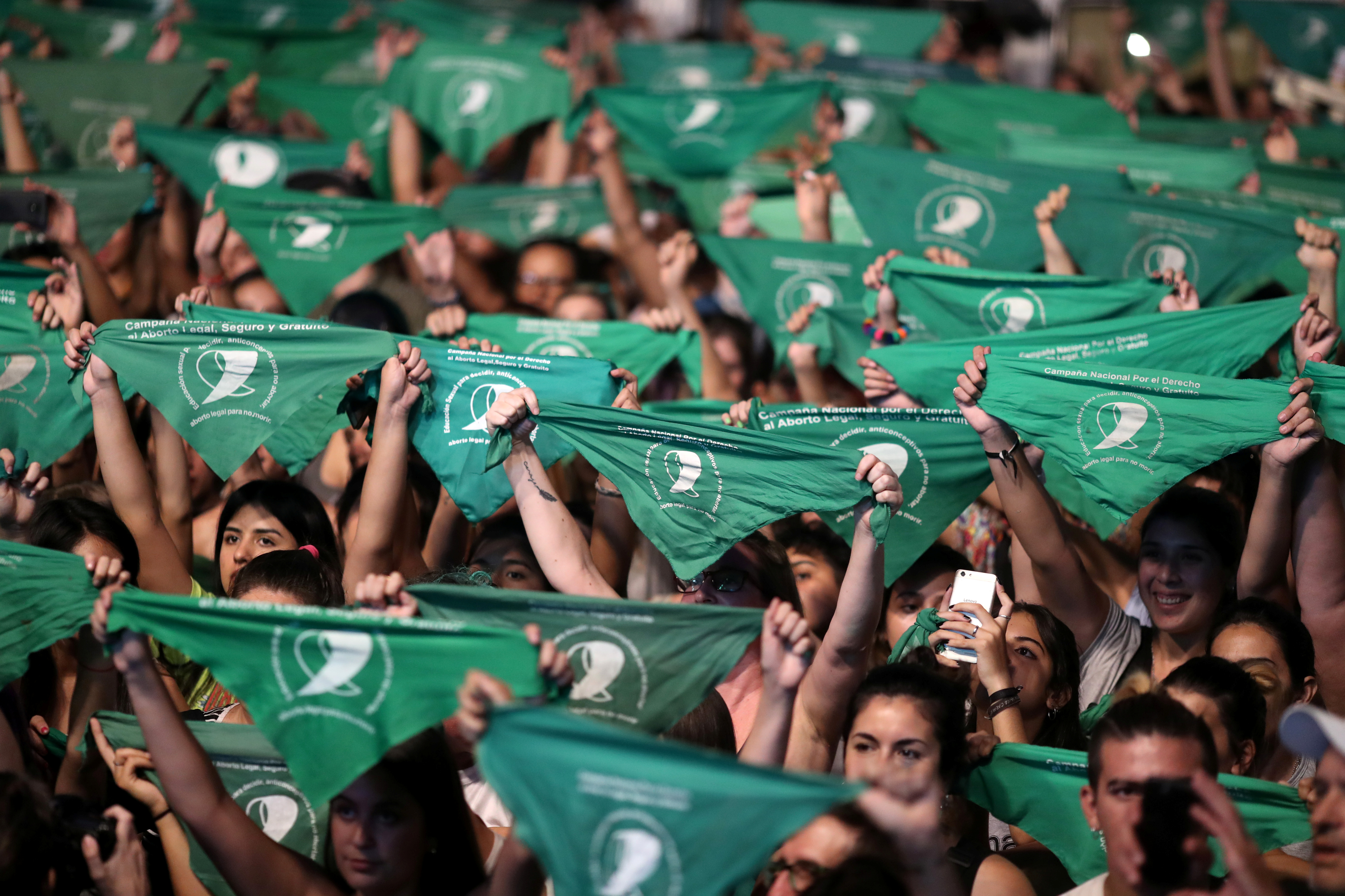 Activists hold green handkerchiefs, symbolizing the abortion rights movement, during a rally to legalize abortion outside the National Congress, in Buenos Aires, Argentina February 19, 2020. 
