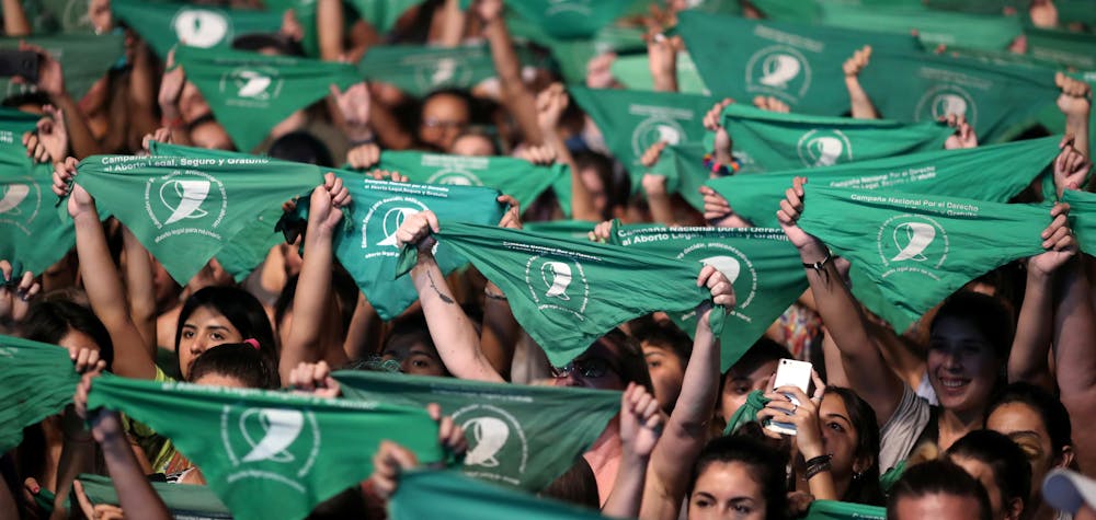 Activists hold green handkerchiefs, symbolizing the abortion rights movement, during a rally to legalize abortion outside the National Congress, in Buenos Aires, Argentina February 19, 2020. 