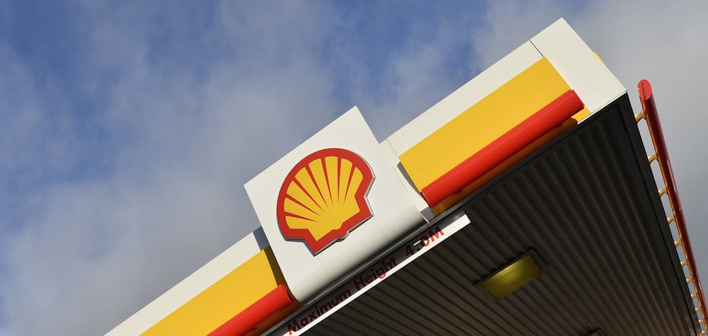 Shell branding is seen at a petrol station in west London, January 29, 2015. Royal Dutch Shell blamed writedowns and forex losses for making almost no money in oil production, its most powerful division, in the last quarter of 2014, causing the company to miss profit forecasts by more than 20 percent. Shell, the largest of the European energy majors, also announced a relatively modest three-year, $15 billion cut in spending to help it weather the plunge in oil prices. REUTERS/Toby Melville (BRITAIN - Tags: BUSINESS ENERGY LOGO)