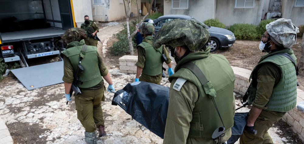  	KFAR AZA, ISRAEL - OCTOBER 10: IDF soldiers remove the body of civilians who were killed days earlier in an attack by Hamas armed groups on this kibbutz near the border with Gaza, on October 10, 2023 in Kfar Aza, Israel. (Photo by Alexi J. Rosenfeld/Getty Images) 