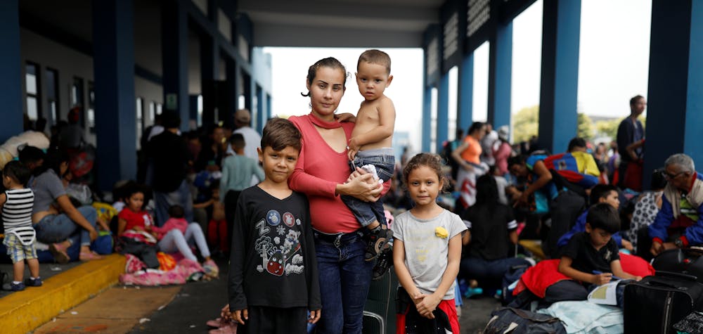 Venezuelan migrant Genesis Valera, 27, who is six months pregnant, poses for a picture with her children Sebastian, 7, Claudia, 6, and Isaias, 2, while they wait to process their documents at the Ecuadorian-Peruvian border service centre, before they continue their journey to Piura, on the outskirts of Tumbes, Peru, June 16, 2019. "I was waiting for a guide and my mobile phone ran out of battery. I kept waiting in San Antonio (in Venezuela) for a while, but the area didn't have electricity. At some point, people arrived and told me, come, come, you will cross (the border) through the pathways," Valera said. "We walked along the pathways with the children... I went through the water, they told me to shut up because the guerrillas were around." Once in Colombia, Genesis travelled by bus but had to walk part of the way to avoid a checkpoint. "We had to wait in the middle of the bushes for two hours, it was dark and very cold, while we waited for the bus to pick us up again," she said. "I came here to fight. I came to have my new baby here and to work and give them the things they need." REUTERS/Carlos Garcia Rawlins      SEARCH "MOTHERS REFUGEE" FOR THIS STORY. SEARCH "WIDER IMAGE" FOR ALL STORIES.