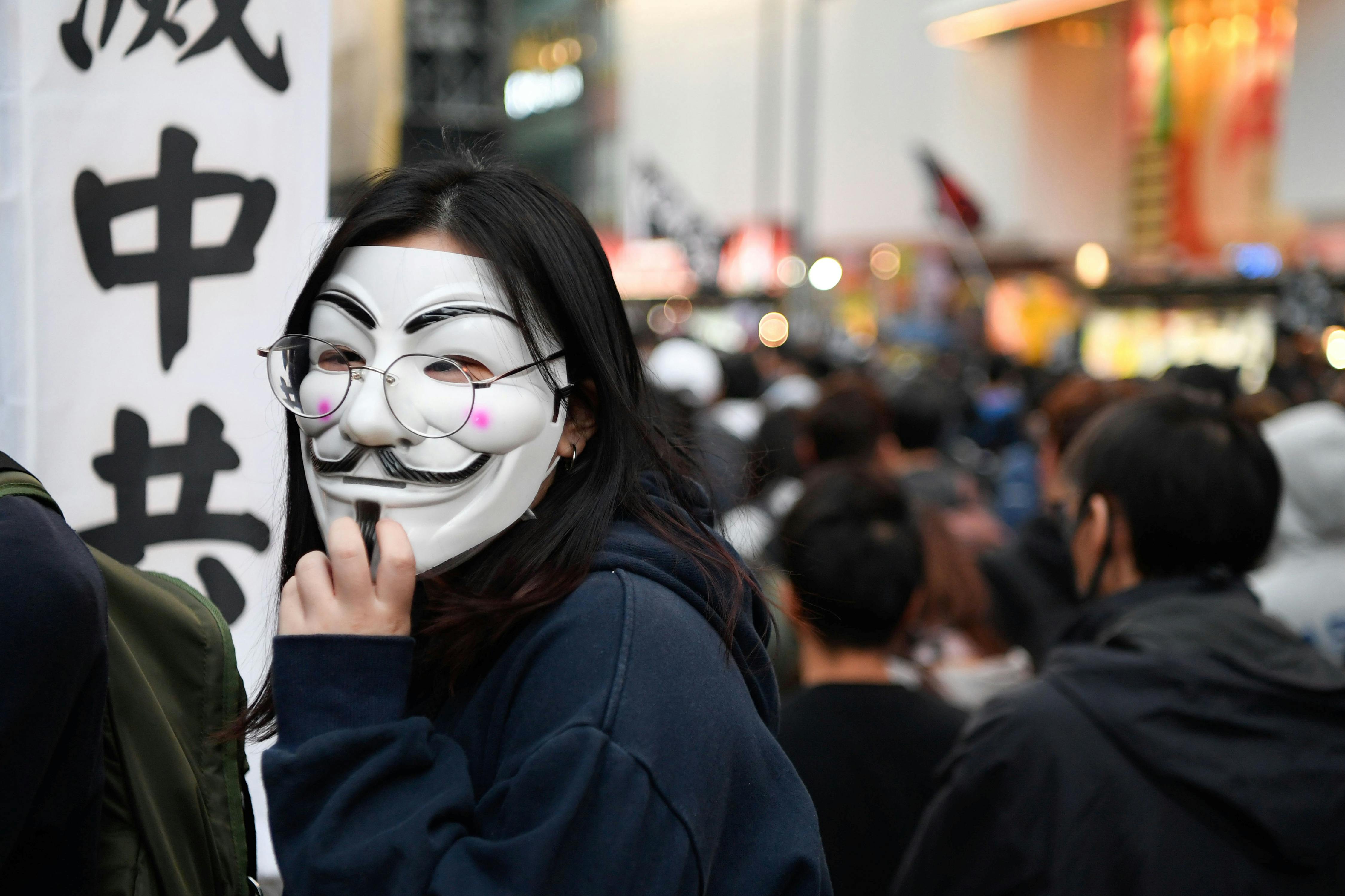 A protester wears a Guy Fawkes mask at a Human Rights Day march in the district of Causeway Bay in Hong Kong, China December 8, 2019. REUTERS/Laurel Chor