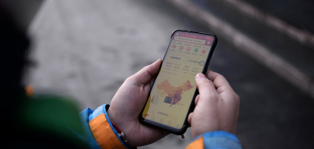 Guo Qiang, a 29-year-old deliveryman for Dada-JD Daojia, checks his phone showing update of the novel coronavirus outbreak, outside a JD.com's 7Fresh chain, in Yizhuang town, Beijing, China February 8, 2020. Picture taken February 8, 2020. REUTERS/Tingshu Wang