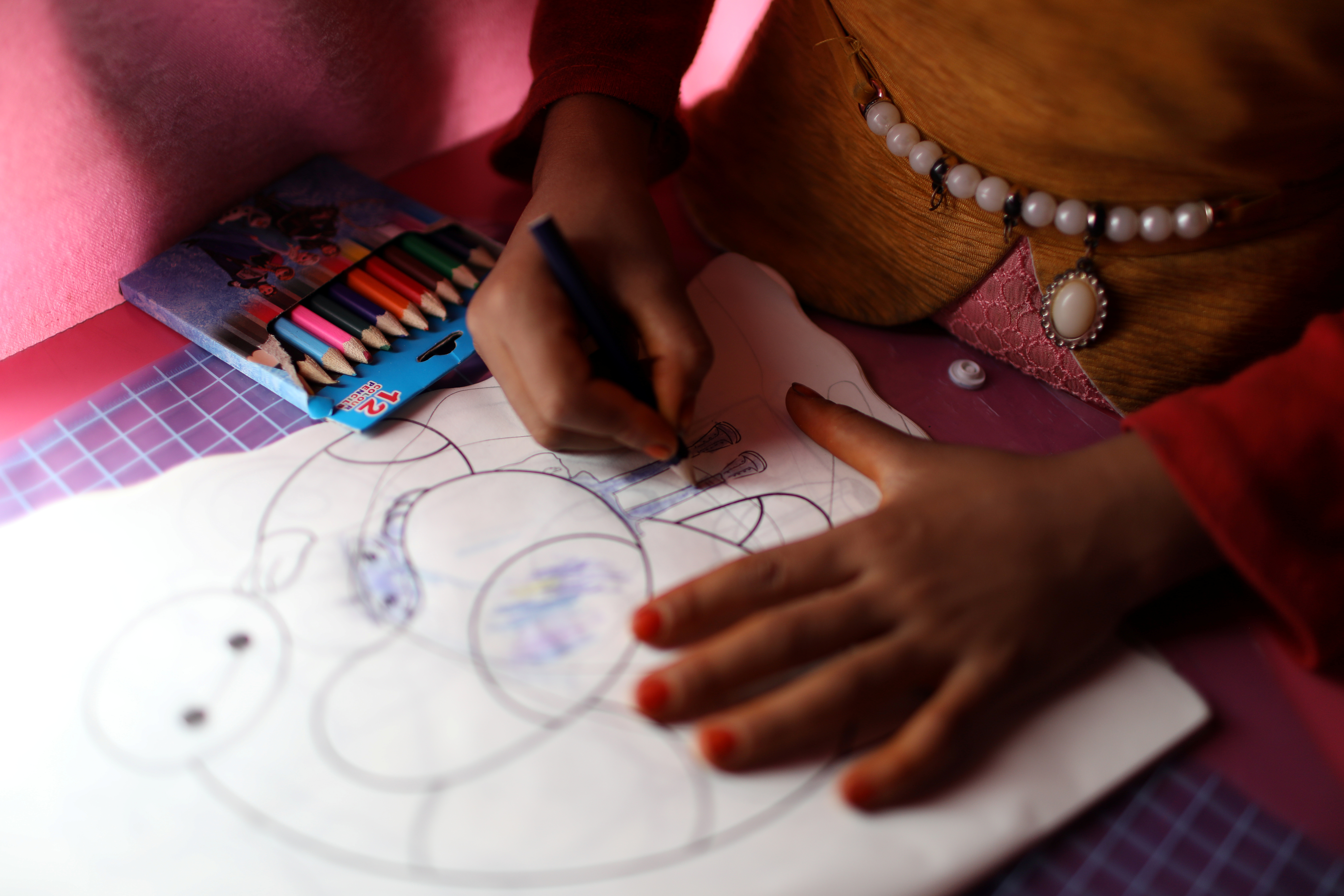 An Iraqi squatter child draws at the mobile school Bus operates by civil society in Baghdad, Iraq November 22, 2018. Picture taken November 22, 2018. 
