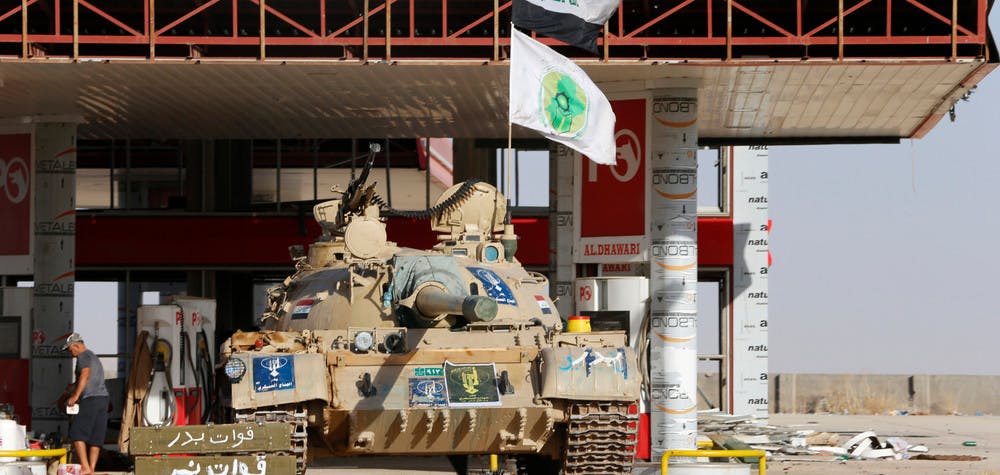 A tank belonging to the Shi'ite Badr Brigade militia takes position in front of a gas station in Suleiman Beg, northern Iraq September 9, 2014. REUTERS/Ahmed Jadallah (IRAQ - Tags: CIVIL UNREST CONFLICT) - RTR45KQ9
