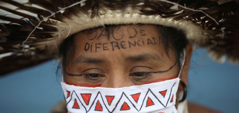 Indigenous midwife Moy from Satere Mawe ethnicity, attends a protest demanding the entrance of traditional healers and better medical care at the Hospital Nilton Lins, which inaugurated a exclusive area for indigenous people to be treated from the coronavirus disease (COVID-19) in Manaus, Brazil June 3, 2020. The message on her forehead reads "Differentiated Health". Picture taken June 3, 2020. REUTERS/Bruno Kelly