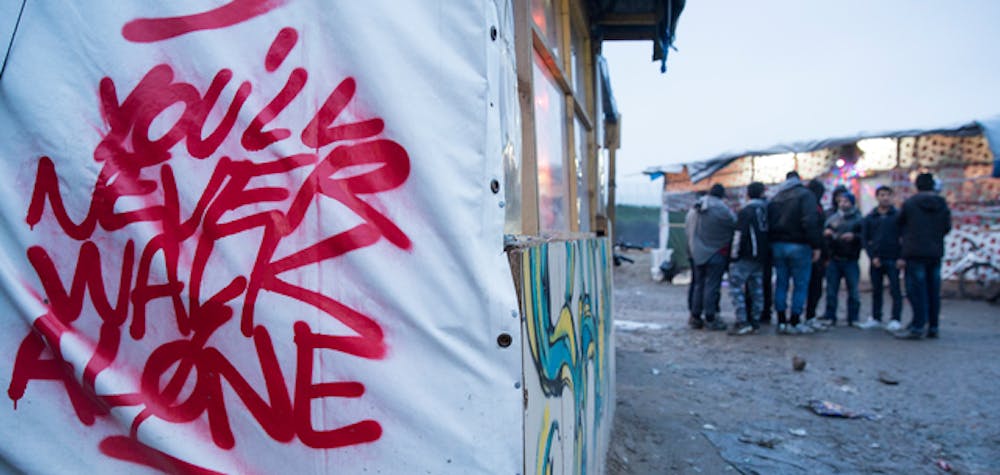 Graffiti is seen close to the entrance of the informal camp in Calais known as 'The Jungle', 23 January, 2016. An estimated 6000 refugees and migrants live in the informal camp situated to the South West of Calais.
