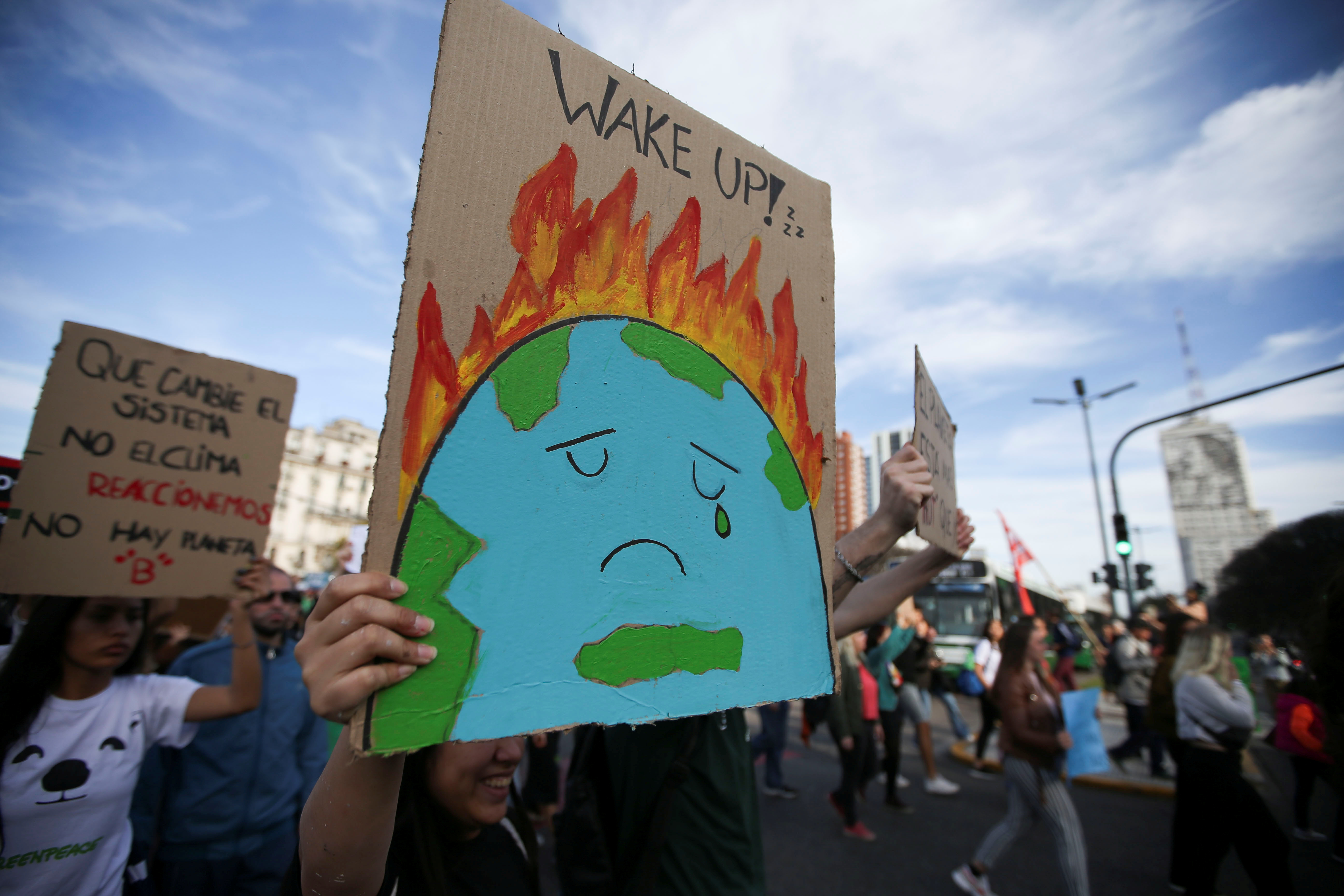 Activists hold placars as they participate in a Fridays for Future march calling for urgent measures to combat climate change in Buenos Aires, Argentina, September 27, 2019. REUTERS/Agustin Marcarian