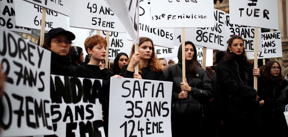 Women hold up signs during a demonstration to protest femicide and violence against women in Paris, France, November 23, 2019. REUTERS/Christian Hartmann
