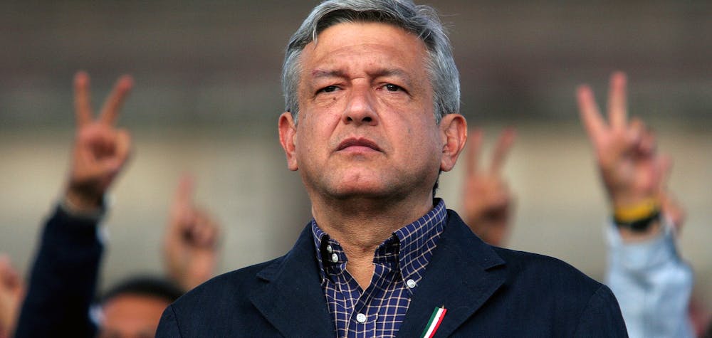 Andres Manuel Lopez Obrador, presidential candidate of the Party of the Democratic Revolution (PRD), looks at his supporters in central Zocalo Square, Mexico City August 5, 2006. Obrador angrily vowed to push ahead with street protests that have paralyzed the capital after a top court on Saturday rejected his demand for a full recount in a presidential vote he says was stolen from him. REUTERS/Tomas Bravo (MEXICO)