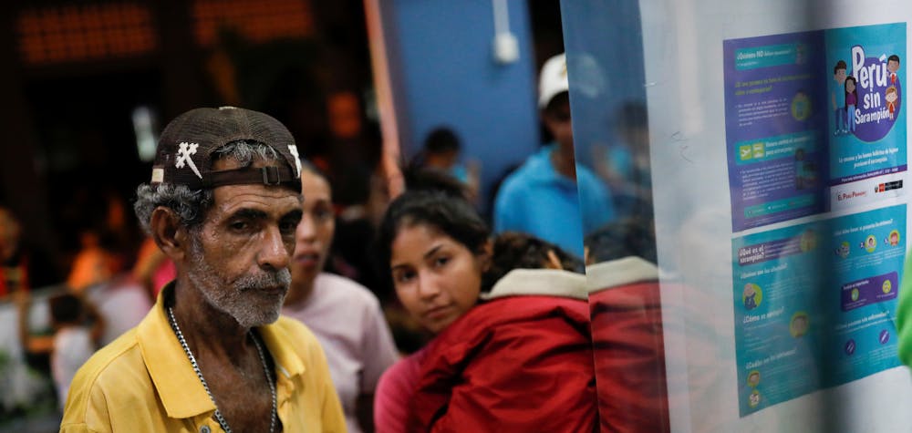 Venezuelan migrants queue to get vaccinated at the Ecuadorian-Peruvian border service center, before continuing their journey on the outskirts of Tumbes, Peru June 14, 2019. Picture taken June 14, 2019. REUTERS/Carlos Garcia Rawlins