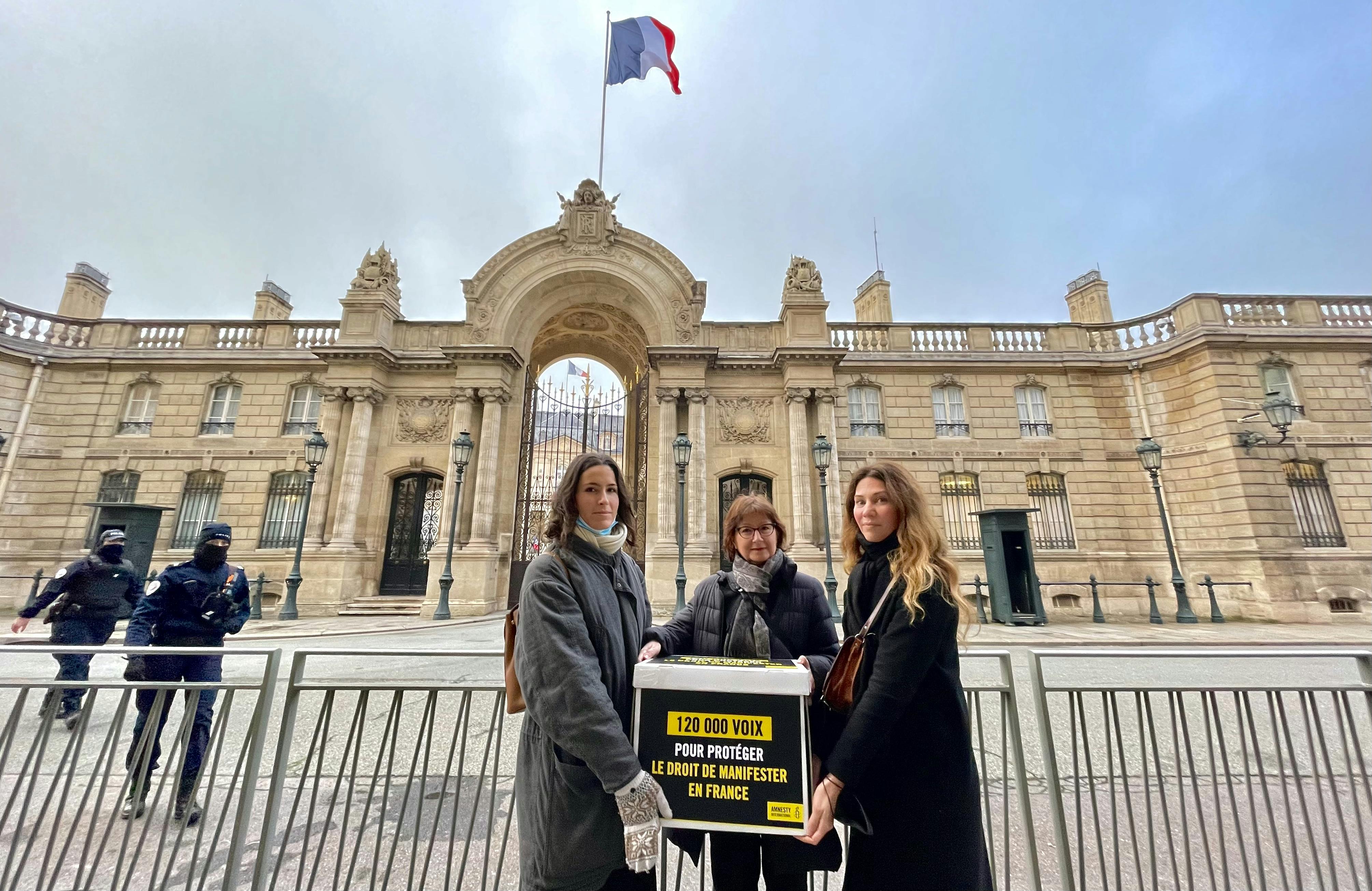 Cécile Coudriou la présidente d'Amnesty International France remet à l’Élysée une pétition demandant la protection du droit de manifester en France, le 7 décembre 2021 / © Amnesty International