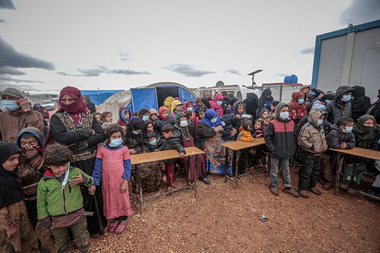  	IDLIB, SYRIA - MARCH 18 : People, mostly children, wear masks as a preventive measure against coronavirus (Covid-19) as Idlib Health Directorate and Civil Defense Crews along with local charities carry out disinfection works at schools and tent cities in Idlib, Syria on March 18, 2020. 
