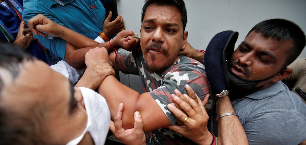 An activist form India's main opposition Congress party is detained by police during a protest demanding postponement of admission tests to medical and engineering schools amidst the spread of the coronavirus disease (COVID-19), in Ahmedabad, India, August 28, 2020. REUTERS/Amit Dave