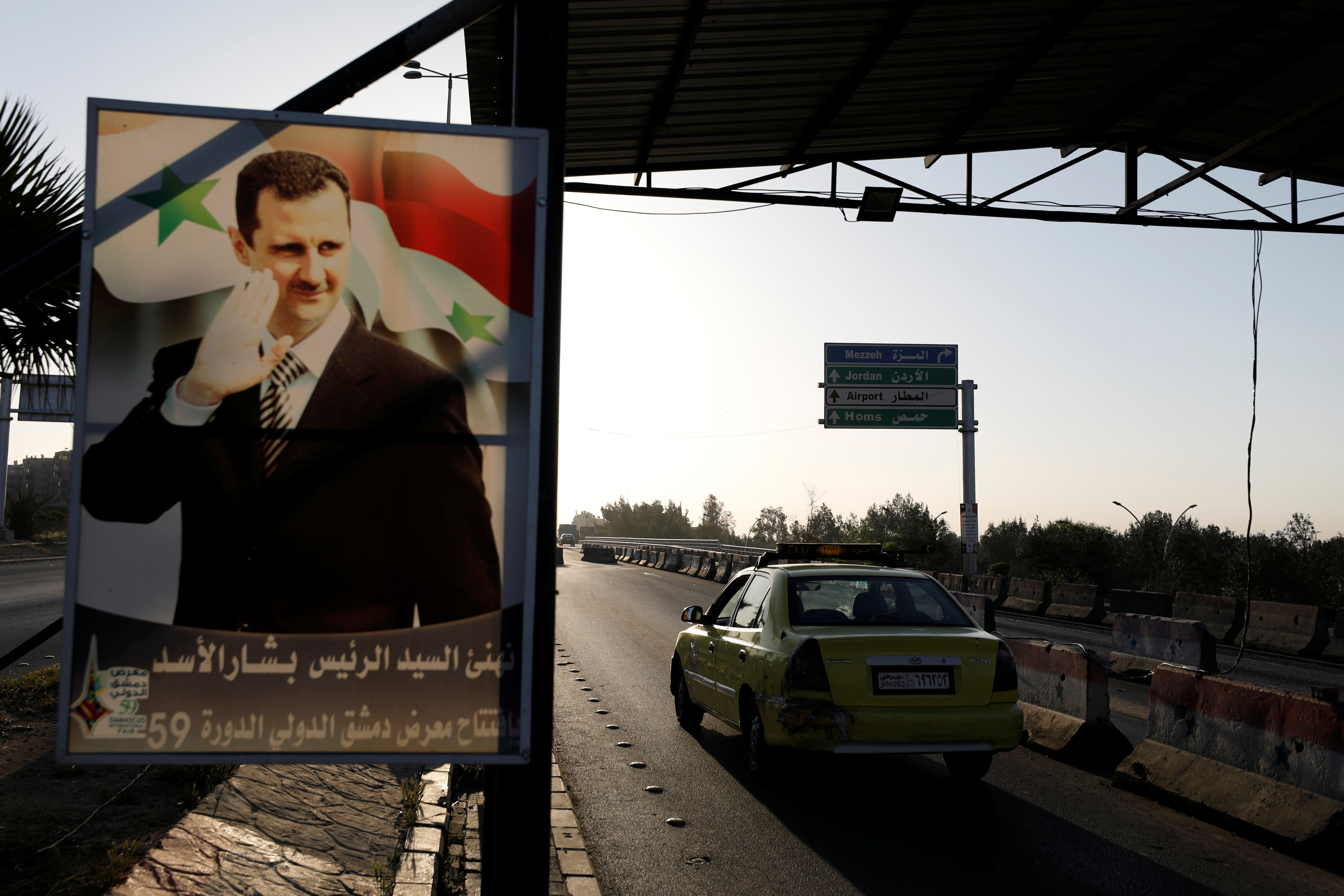 bbcb0d18-a9f4-469d-adeb-9736fb3655c9_A+poster+of+Syrian+President+Bashar+al-Assad+is+seen+on+the+main+road+to+the+airport+in+Damascus.JPG?auto=compress,format&rect=0,312,4918,2342&w=1680&h=800