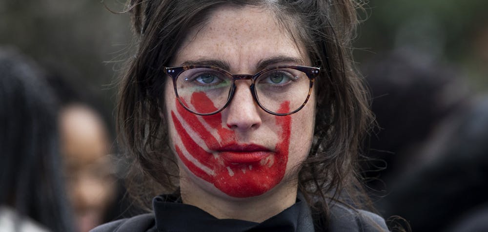 MADRID, SPAIN - MARCH 08: A woman wears red face paint depicting a hand during a protest during the International Women's Day on March 08, 2020 in Madrid, Spain. Spain celebrates International Women's Day today with countless protests scheduled throughout the day across the country in defense of their rights. Some of feminist movement's demands are equal working rights, women's right to abortion and an end to violence against women, to racism and to xenophobia across the globe. (Photo by Pablo Blazquez Dominguez/Getty Images) 
