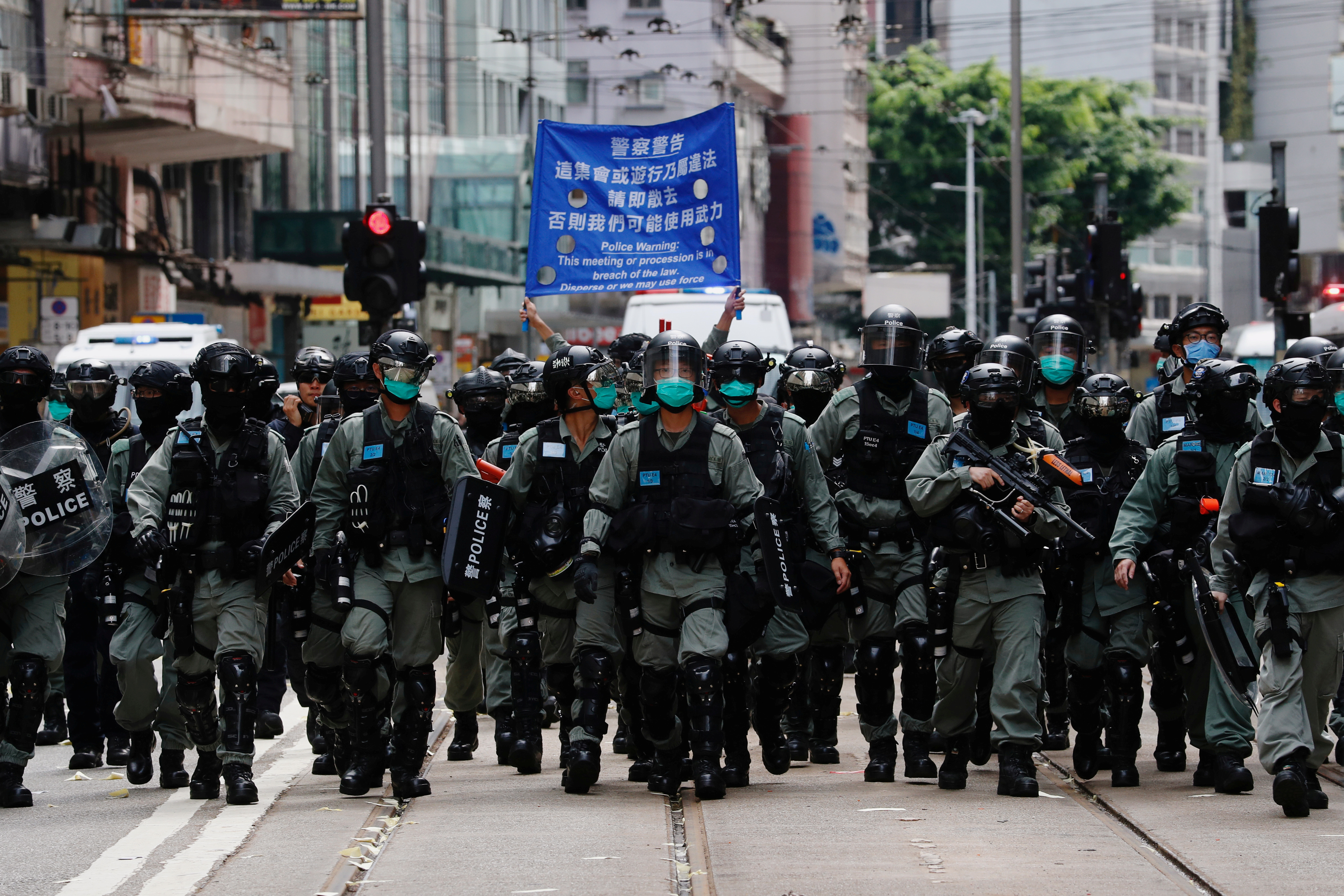 Riot police officers walk as anti-national security law protesters march during the anniversary of Hong Kong's handover to China from Britain, in Hong Kong, China July 1, 2020. REUTERS/Tyrone Siu  REFILE - CORRECTING YEAR