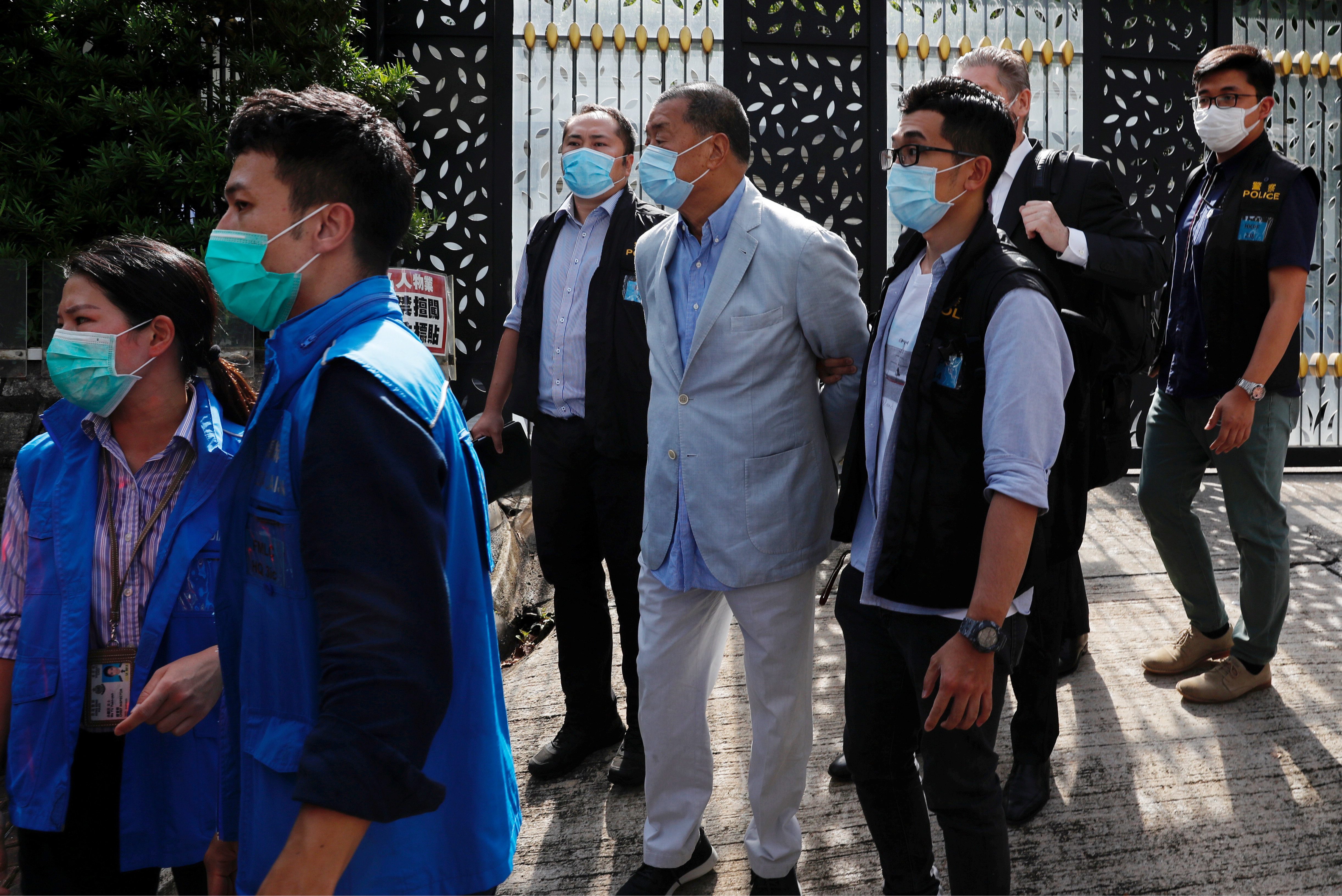 Media mogul Jimmy Lai Chee-ying, founder of Apple Daily (C) is detained by the national security unit in Hong Kong, China August 10, 2020. REUTERS/Tyrone Siu