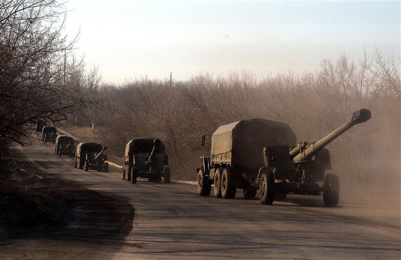 Unmarked military trucks belonging to Pro-Russian separists forces pull cannons as they move as a convoy near eastern Ukrainian city of Yenakiievo on February 14, 2015.
Fighting has raged on in Ukraine, throwing doubts on a ceasefire deal due to take effect over
the weekend, with the US saying Russia is still deploying heavy arms and Kyiv warning that
shelling of civilians had intensified.