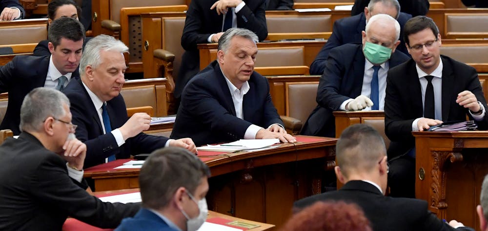 Hungarian Prime Minister Viktor Orban (C) votes with other representatives about the government's bill on the protection against the new coronavirus COVID-19 at the plenary session of the Hungarian Parliament in Budapest, Hungary on March 30, 2020. 
