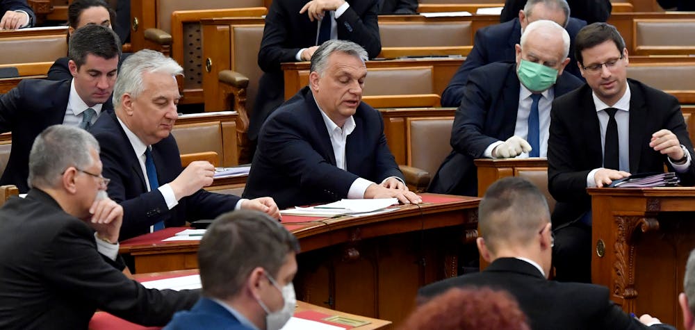 Hungarian Prime Minister Viktor Orban (C) votes with other representatives about the government's bill on the protection against the new coronavirus COVID-19 at the plenary session of the Hungarian Parliament in Budapest, Hungary on March 30, 2020.