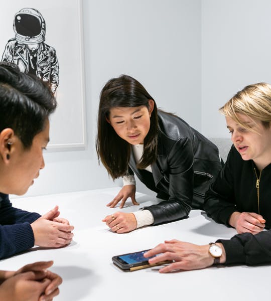 A photo of a team of application engineers ideating an eCommerce app around a table.