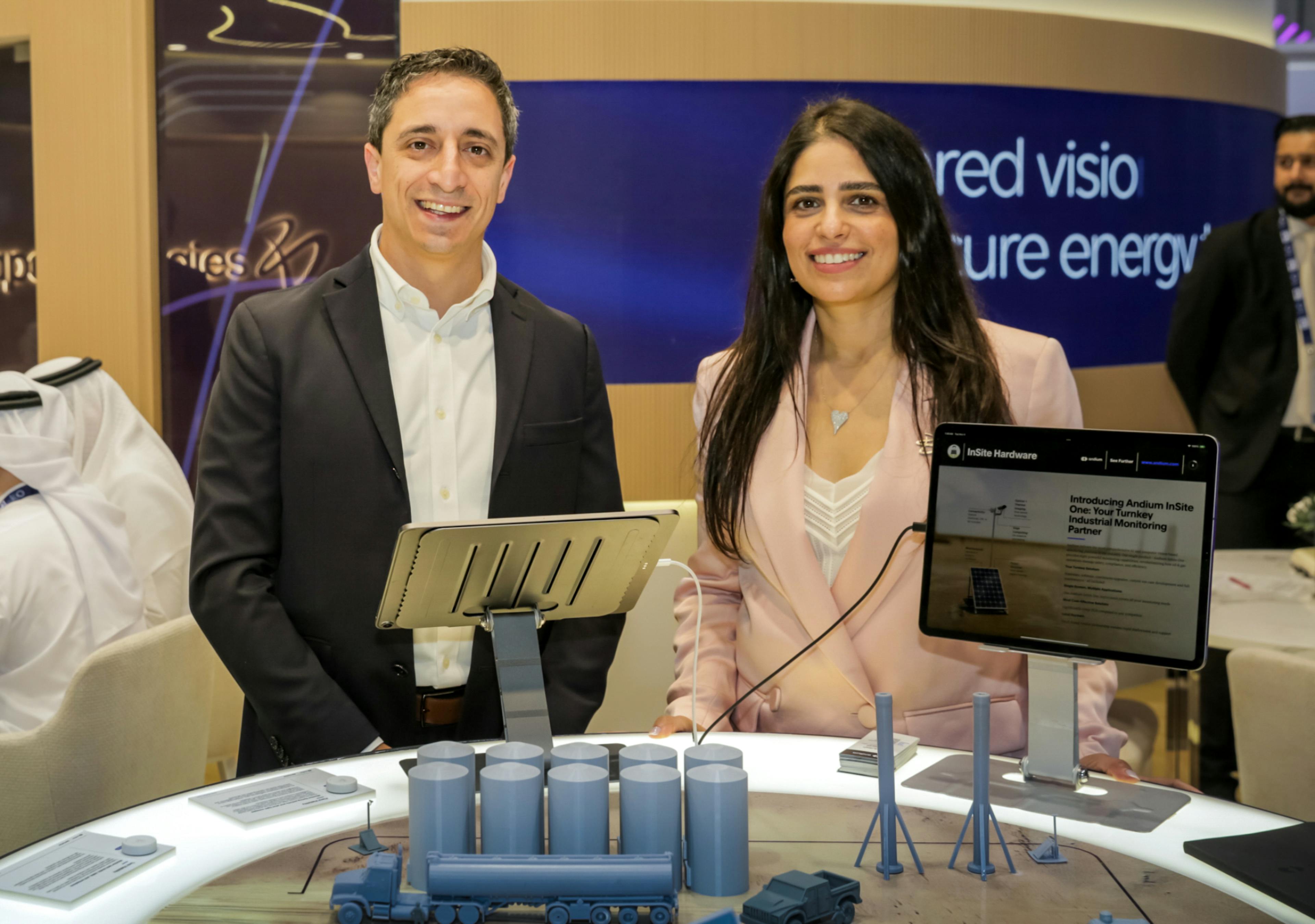 Jory Schwach, CEO of andium.com, and Areije Al Shakar, CEO of BeVentures, standing together at the Andium booth showcasing the InSite One industrial monitoring platform at ADIPEC 2025 event.
