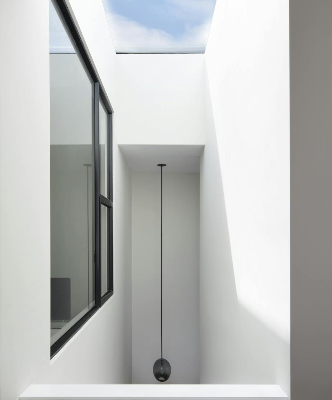 Andrew-Mann-Architecture-California-Historic-Cottage-Row-Skylight-with-Black-Window-Frame-view