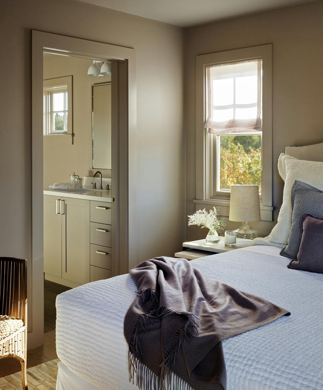 Andrew-Mann-Architecture-California-Wine-Country-Bedroom-Corner-with-Window-Bathroom-View