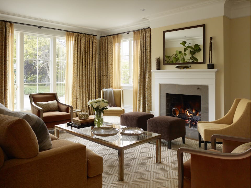 Andrew-Mann-Architecture-California-Spanish-Revival-Living-Room-with-Foreplace-Lit