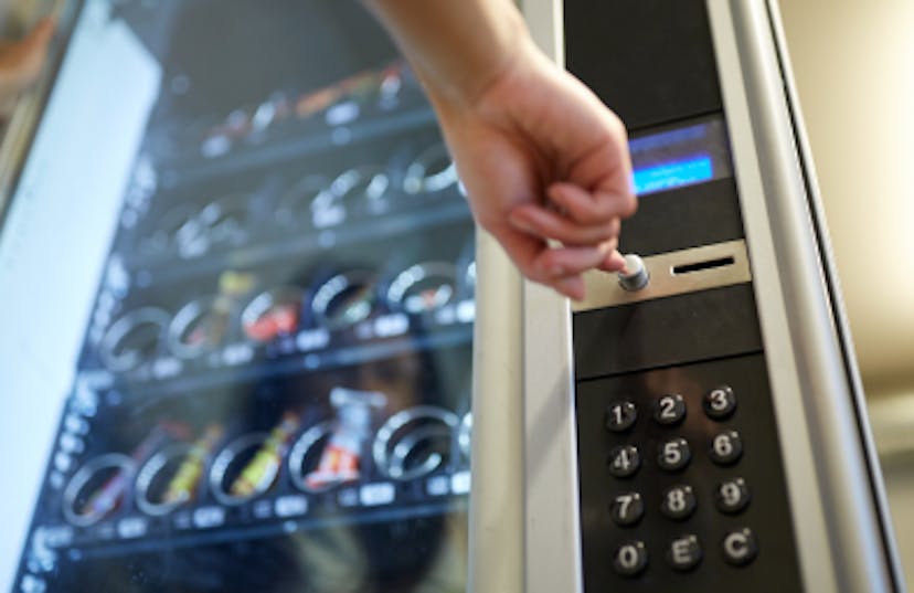 Man pressing buttons on vending machine