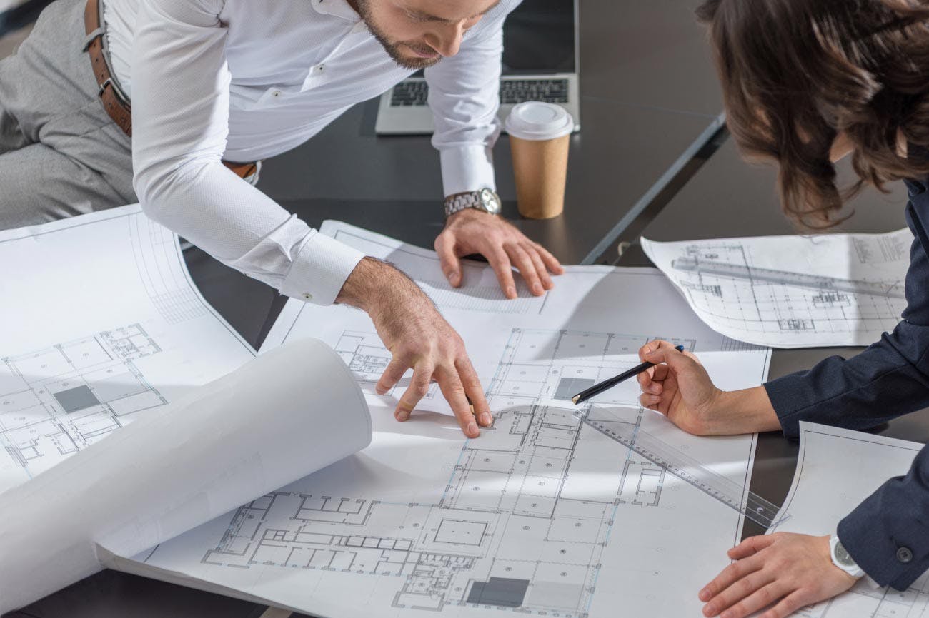 Two people looking at a floor plan