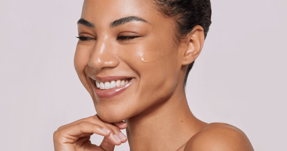 A female patient smiling after receiving gentle facial treatment