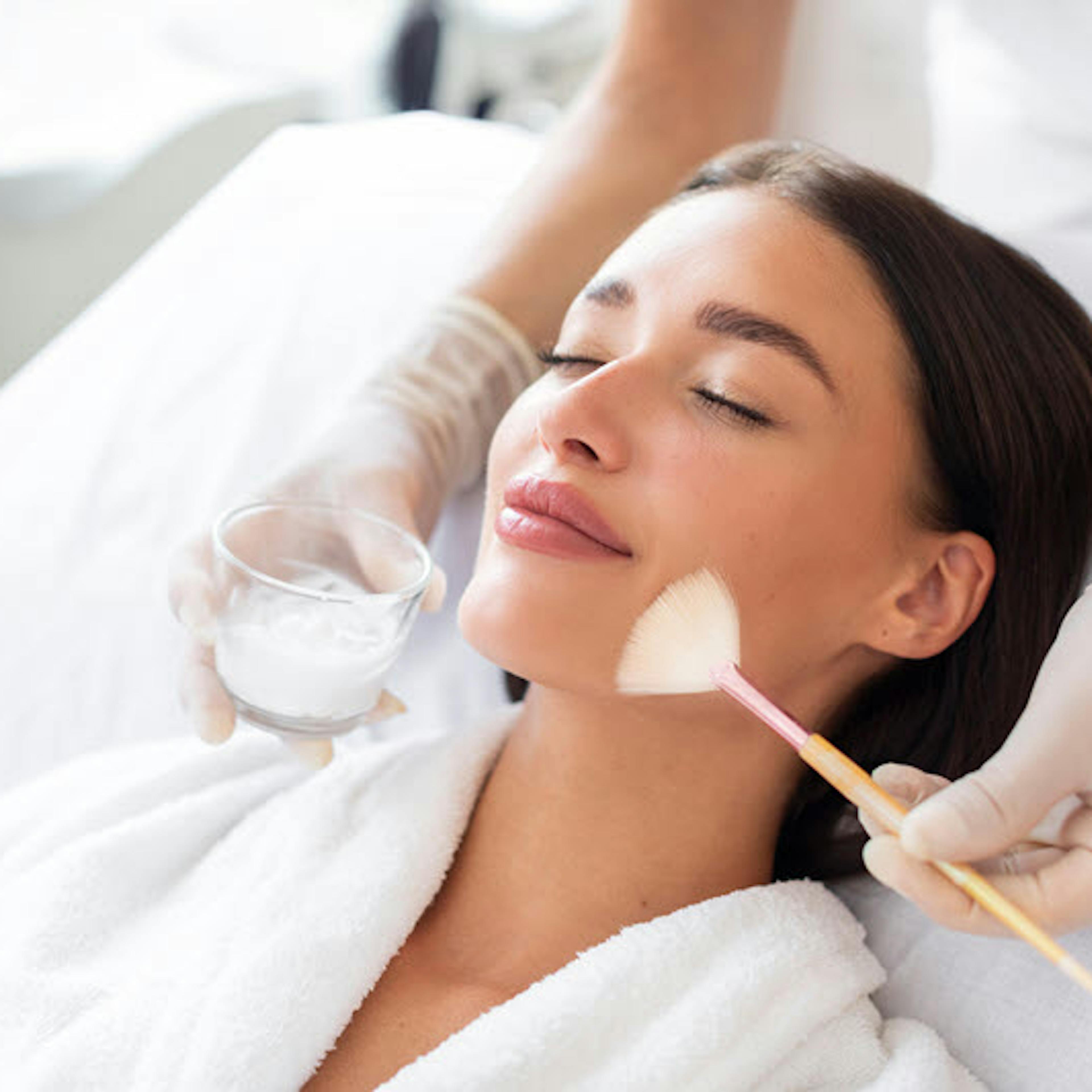 A female patient receiving chemical peel treatment
