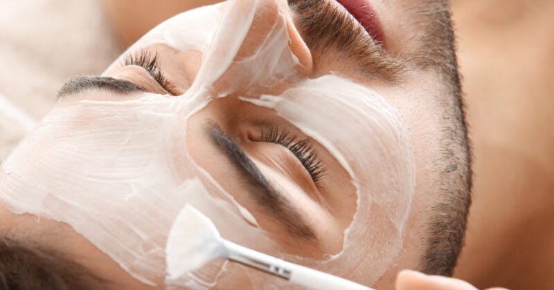 A man receiving brightening facial treatment