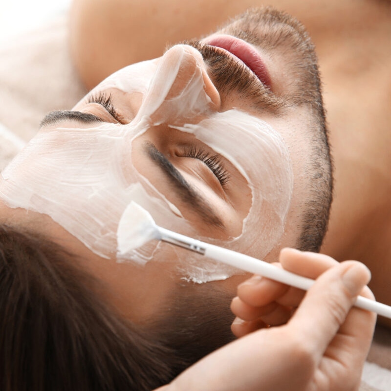 A man receiving brightening facial treatment