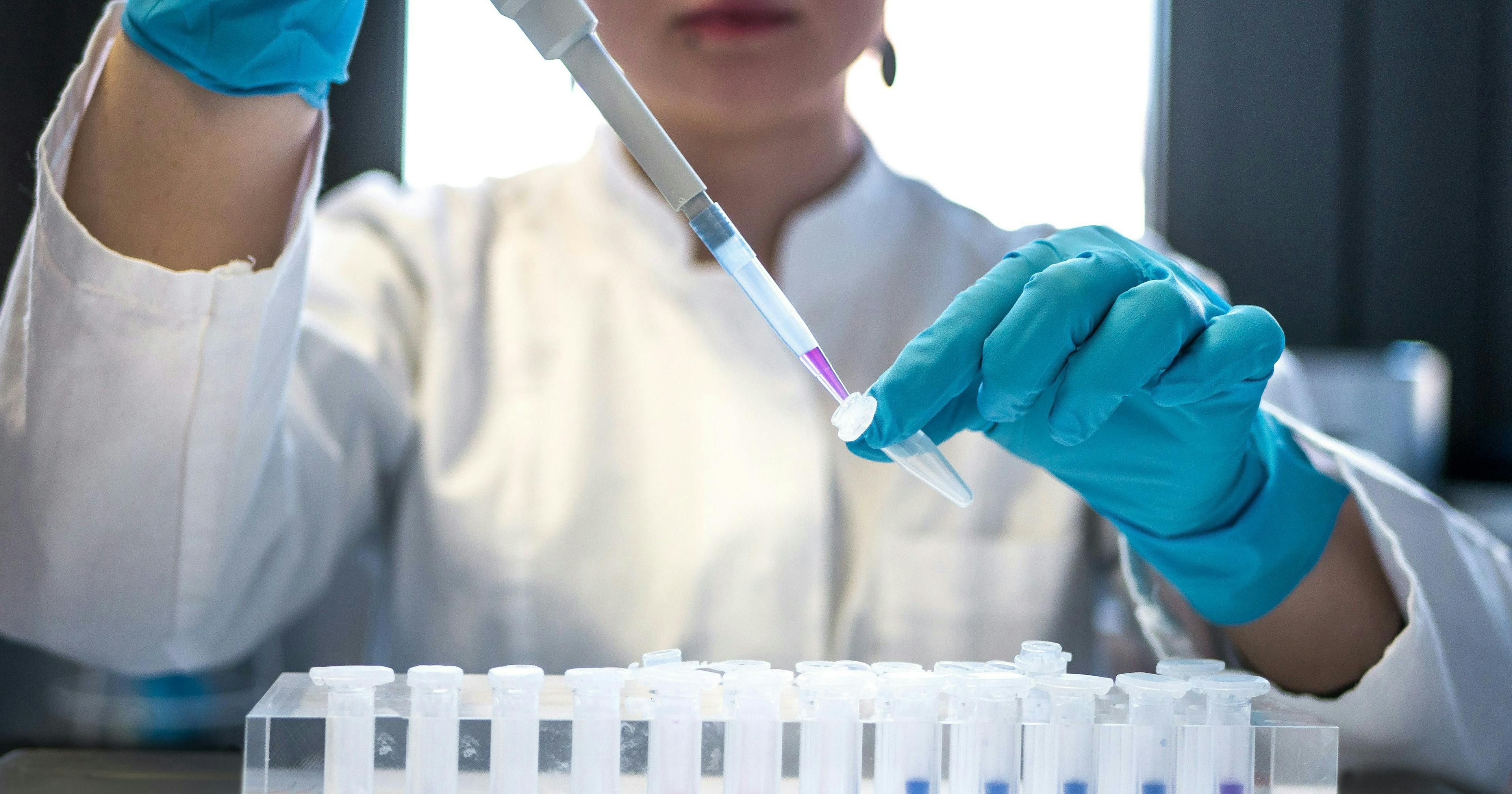 A medical professional working with sample data in a lab