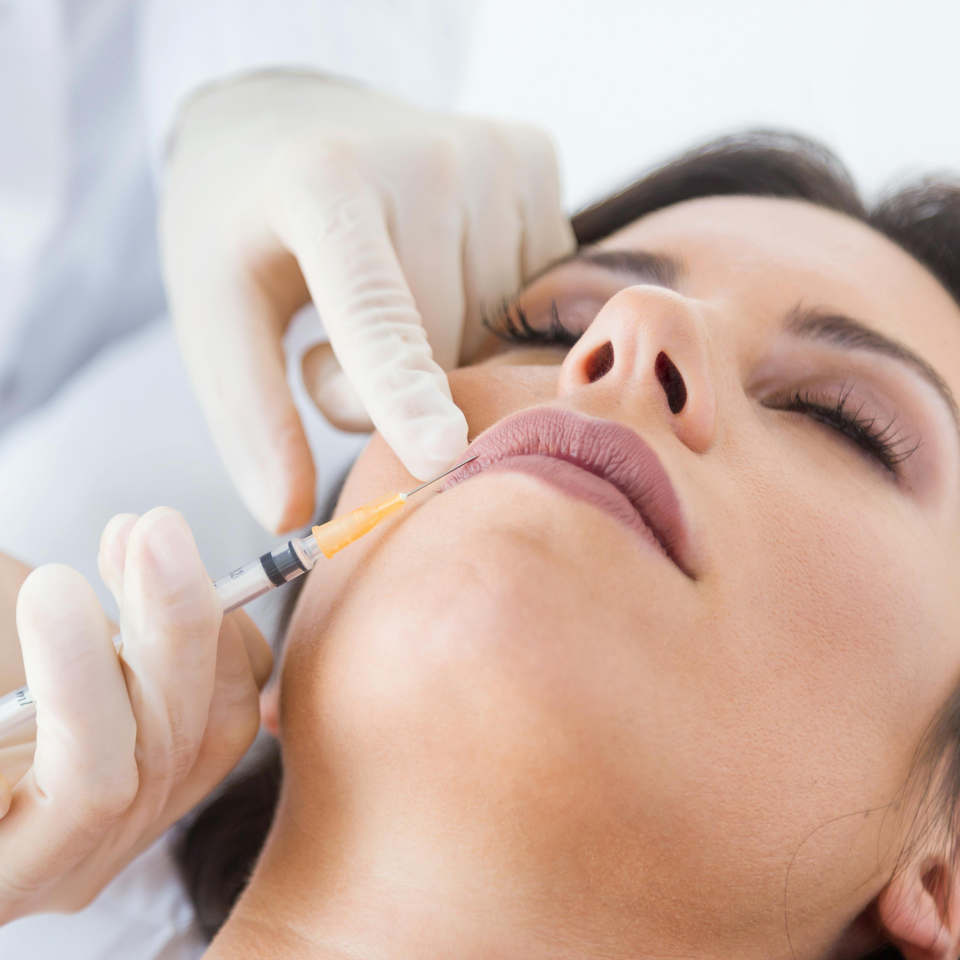A female patient receiving dermal filler treatment