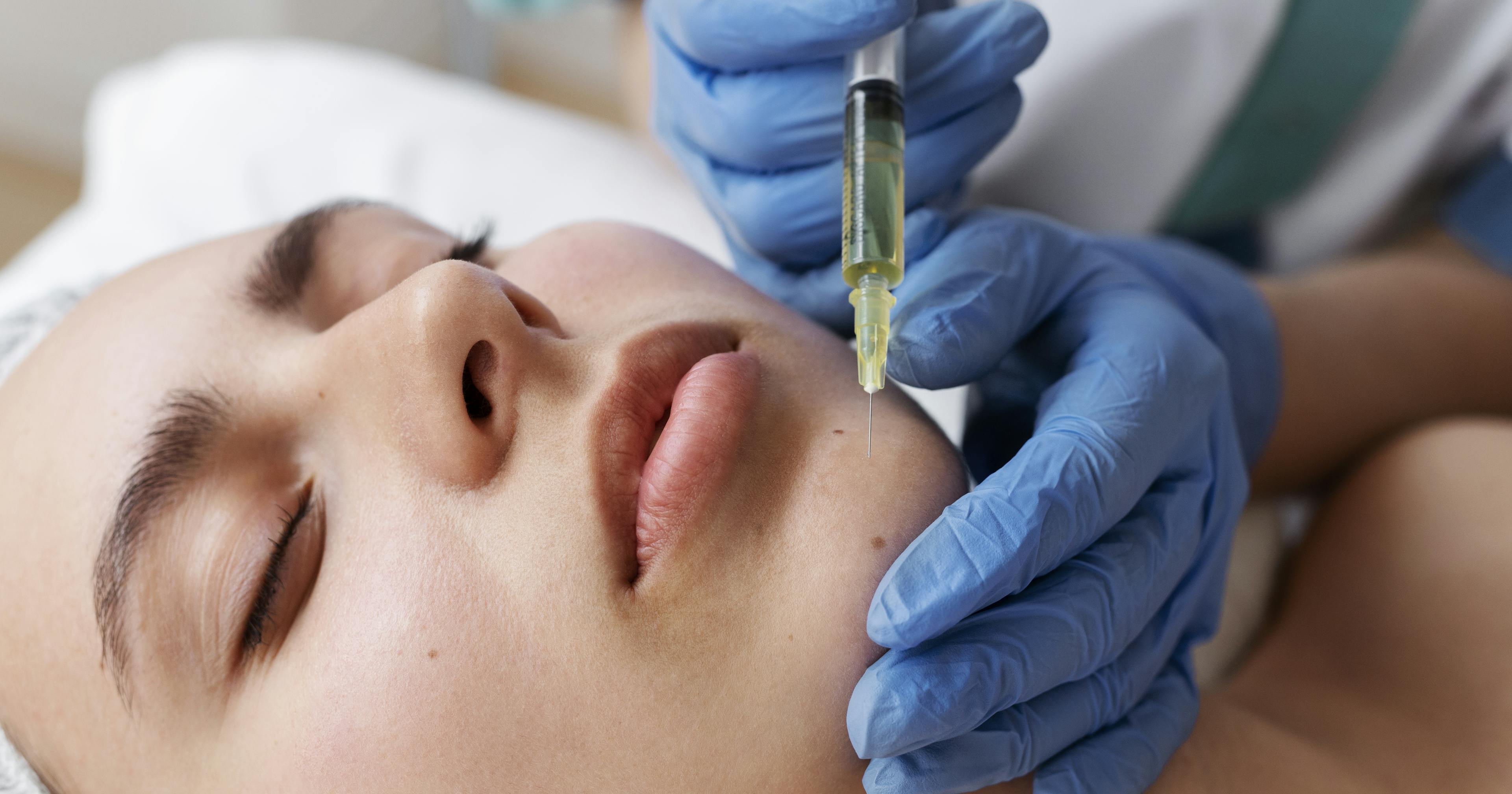 A female patient receiving chin filler treatment