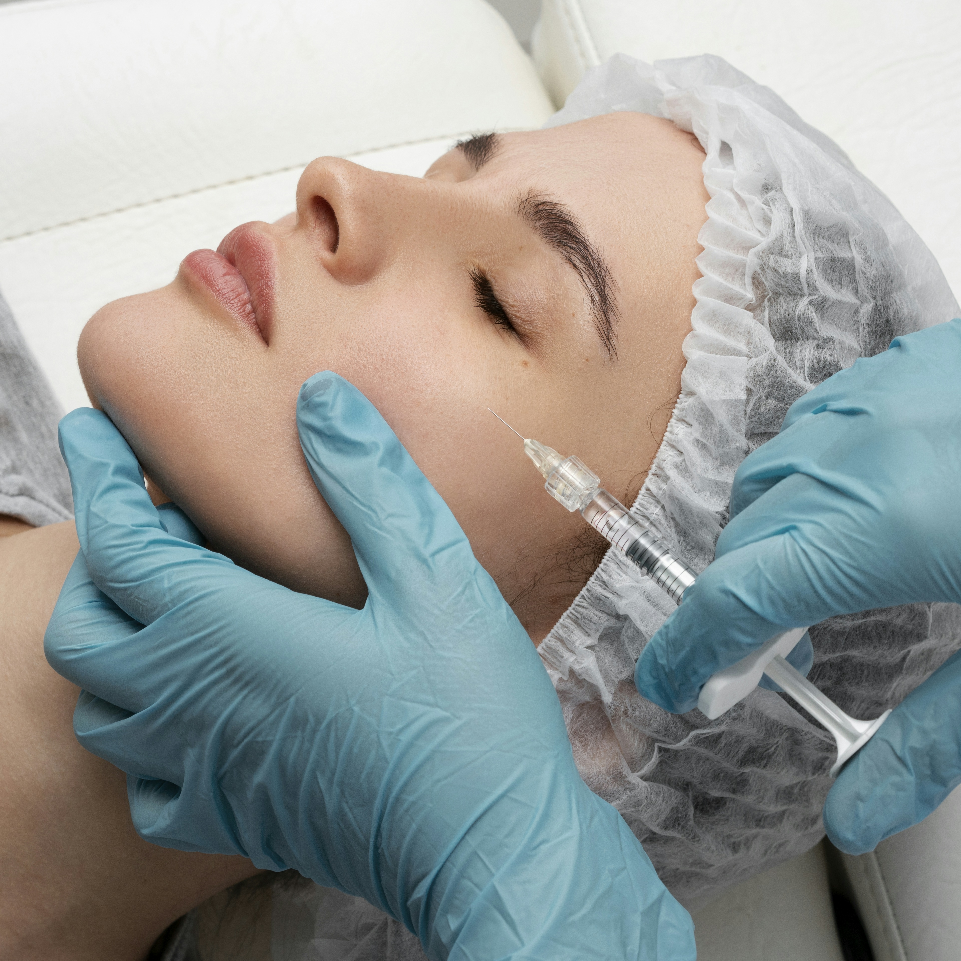 Female patient receiving cheek dermal filler treatment