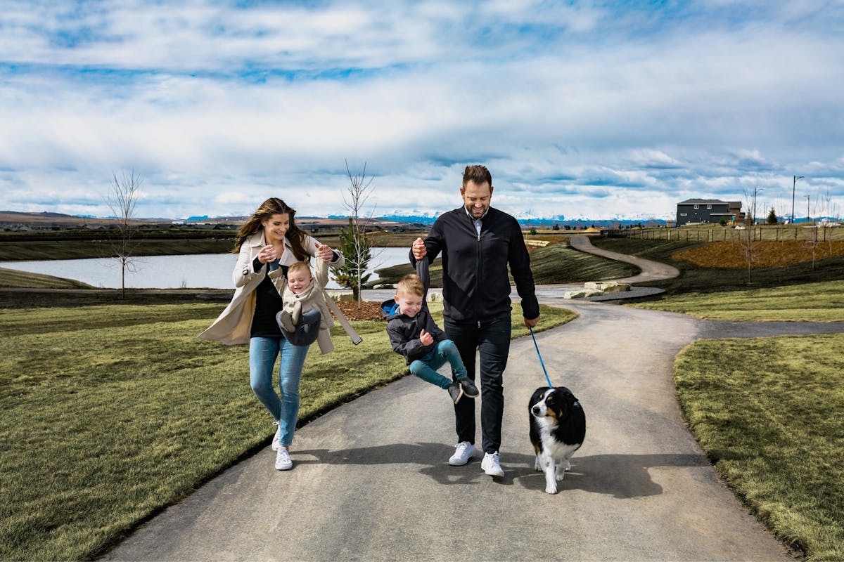 Family walking dog on pathway