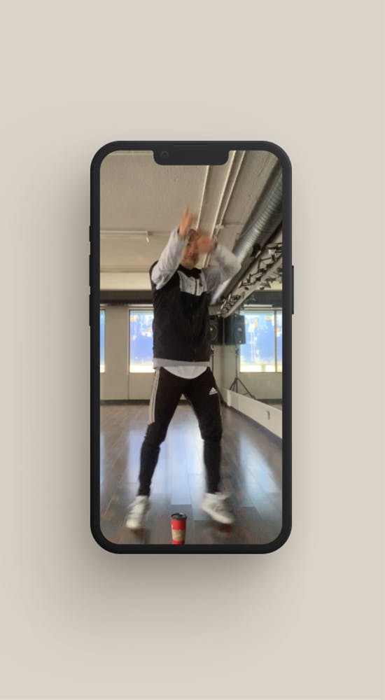 iPhone with man dancing on the screen