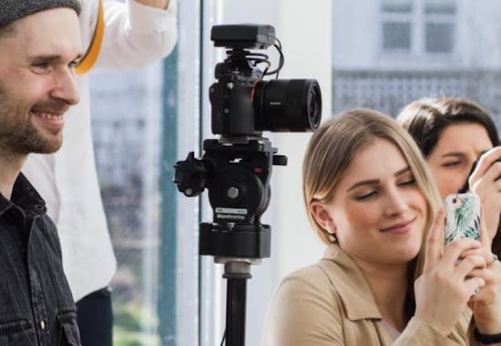 Three Antisocial team members on site by a camera.
